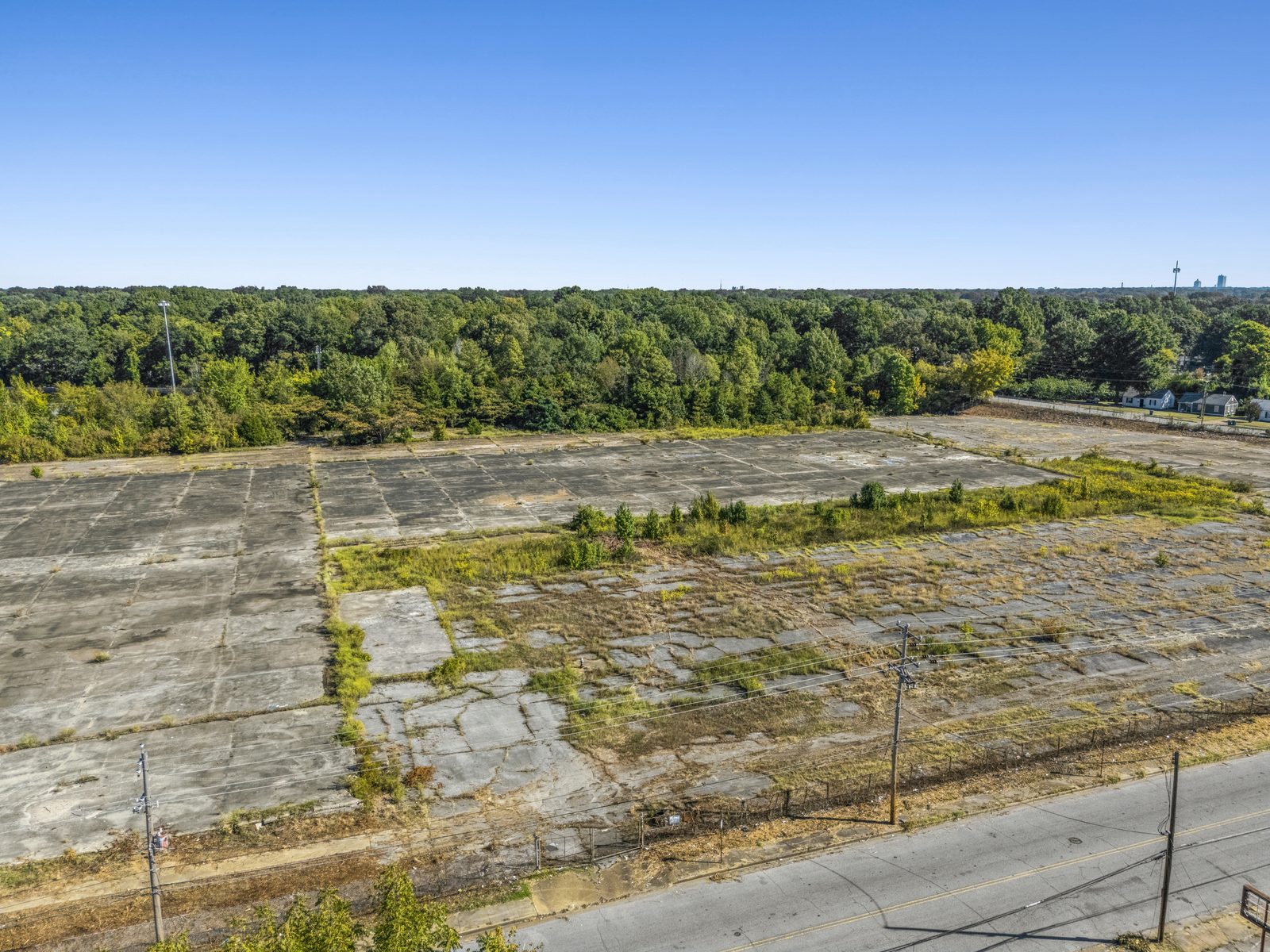 Aerial of the concrete pad from above the street, with the downtown Memphis skyline on the horizon.